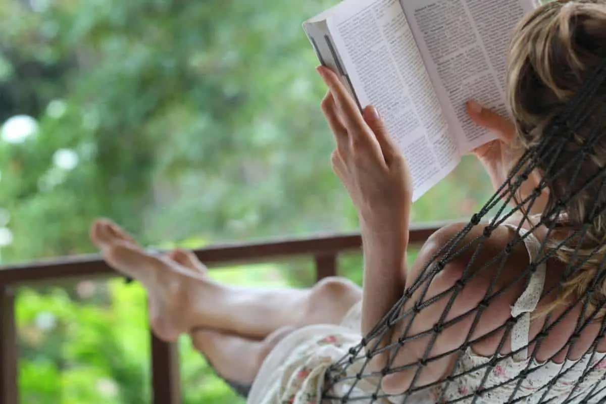 woman reading in hammock outside