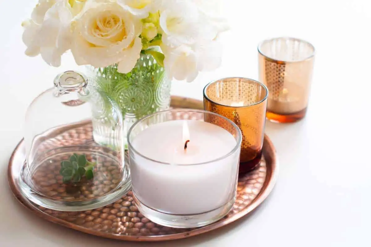 candles and vase on wooden tray